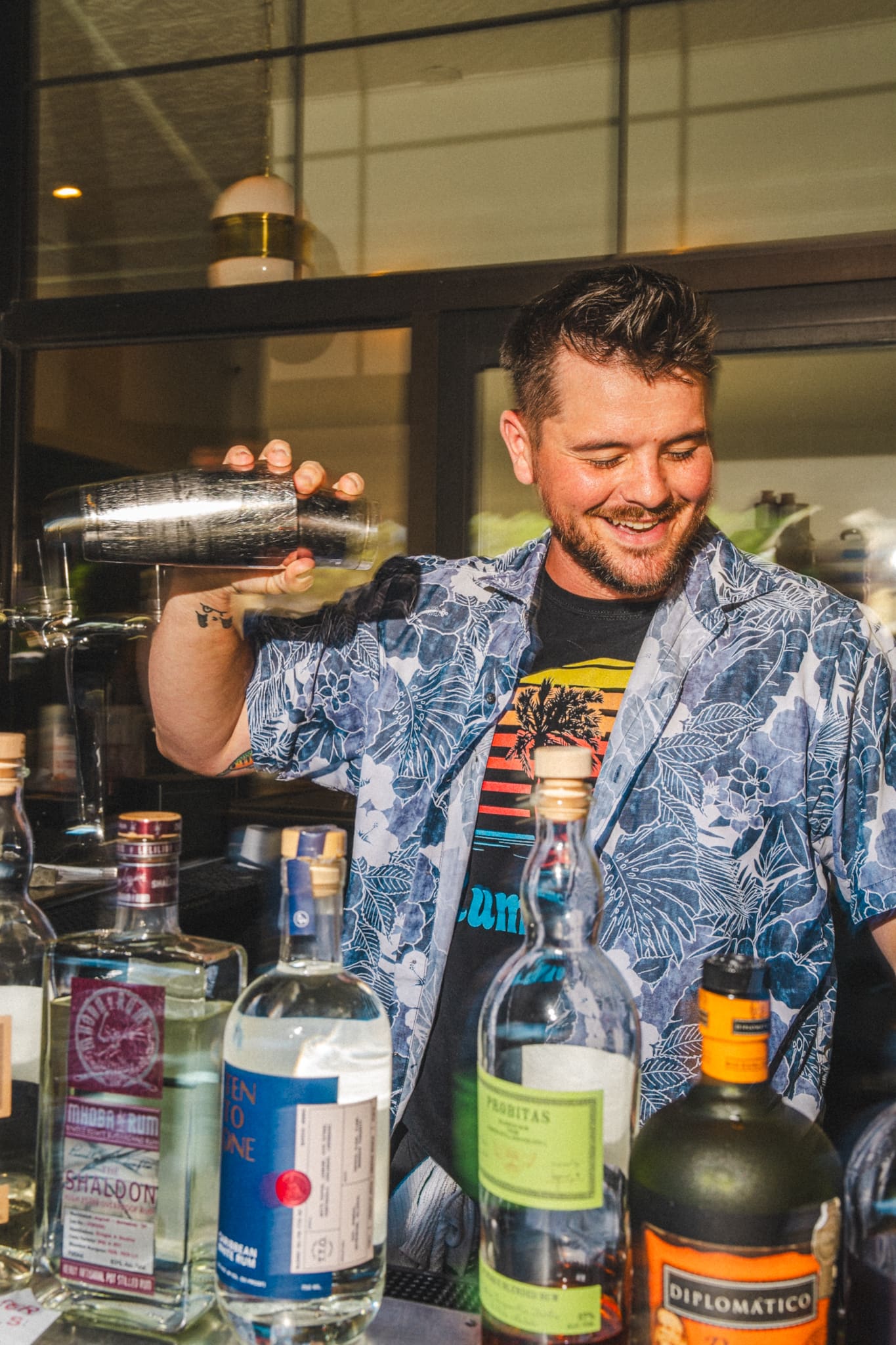 Shaking a cocktail behind the Coop bar
